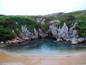 A praia de Gulpiyuri tem água salgada e cristalina, que chega por túneis entre as rochas