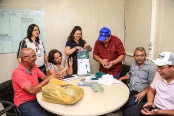 Momento em que representante da comunidade quilombola Lagoa das Pedras recebe 54 carteiras de identidade solicitadas para o Dia D do Governo Presente e uniformes de futebol